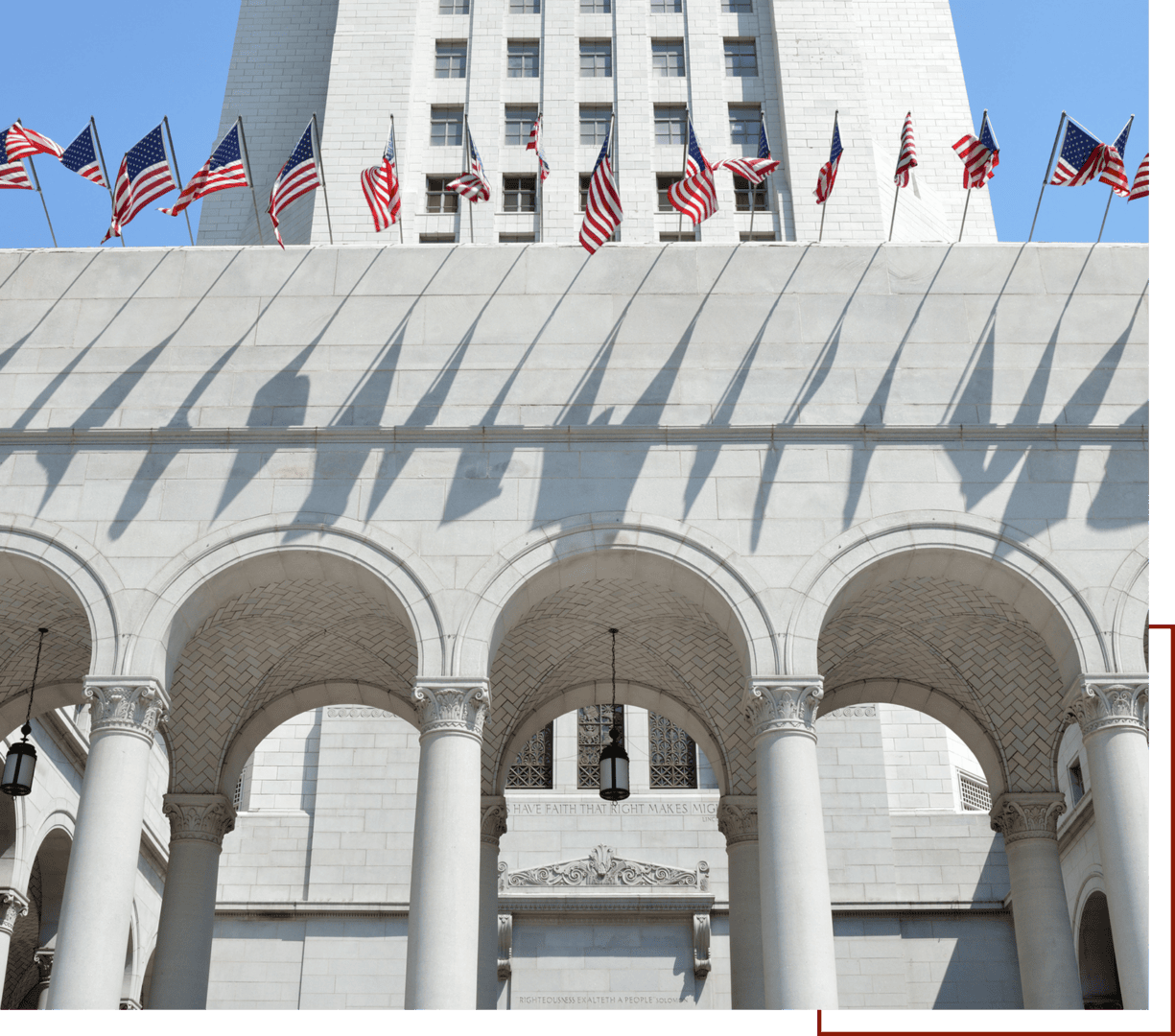 Flags casting shadows on building arches