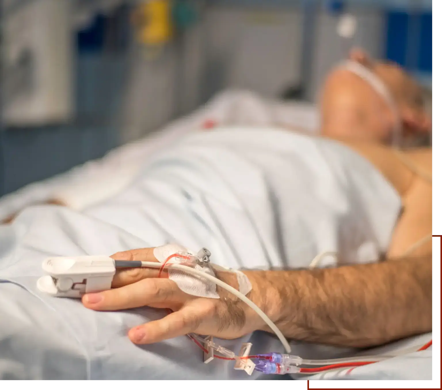 Man laying in a hospital bed with an IV machine attached to his arm